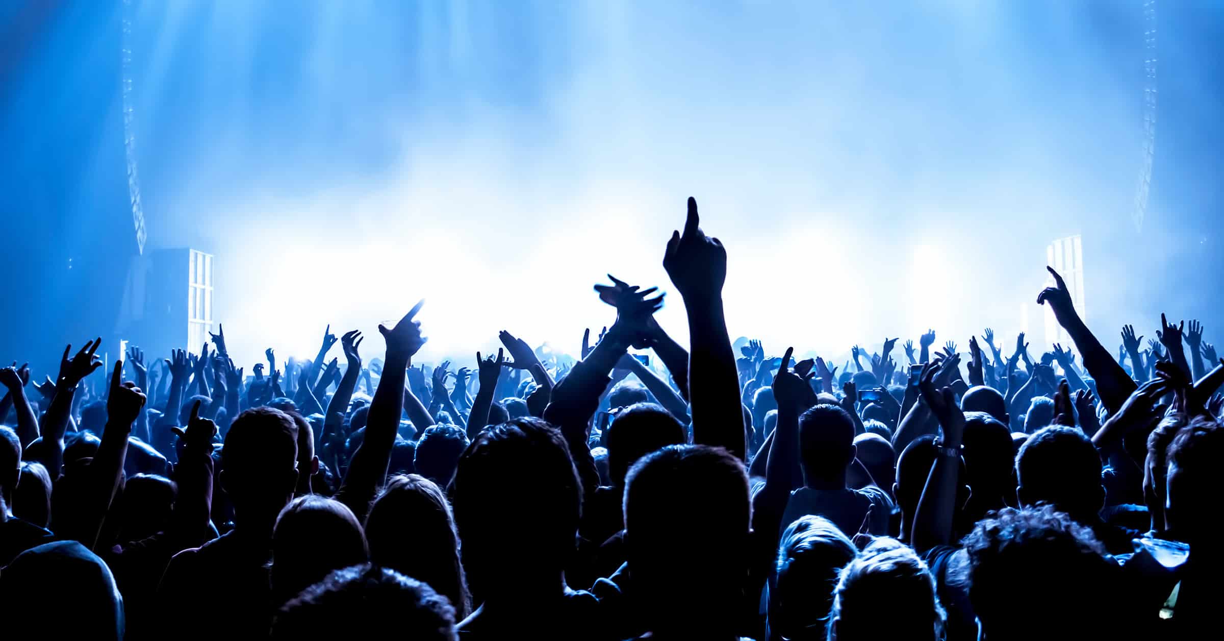 fans at an event having fun with hands up